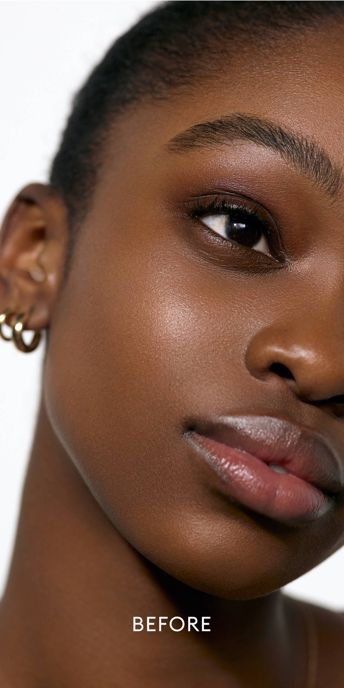 Before image of a deep skin tone model wearing a deep shade of the Solar Infusion Soft-Focus Cream in Capri 1