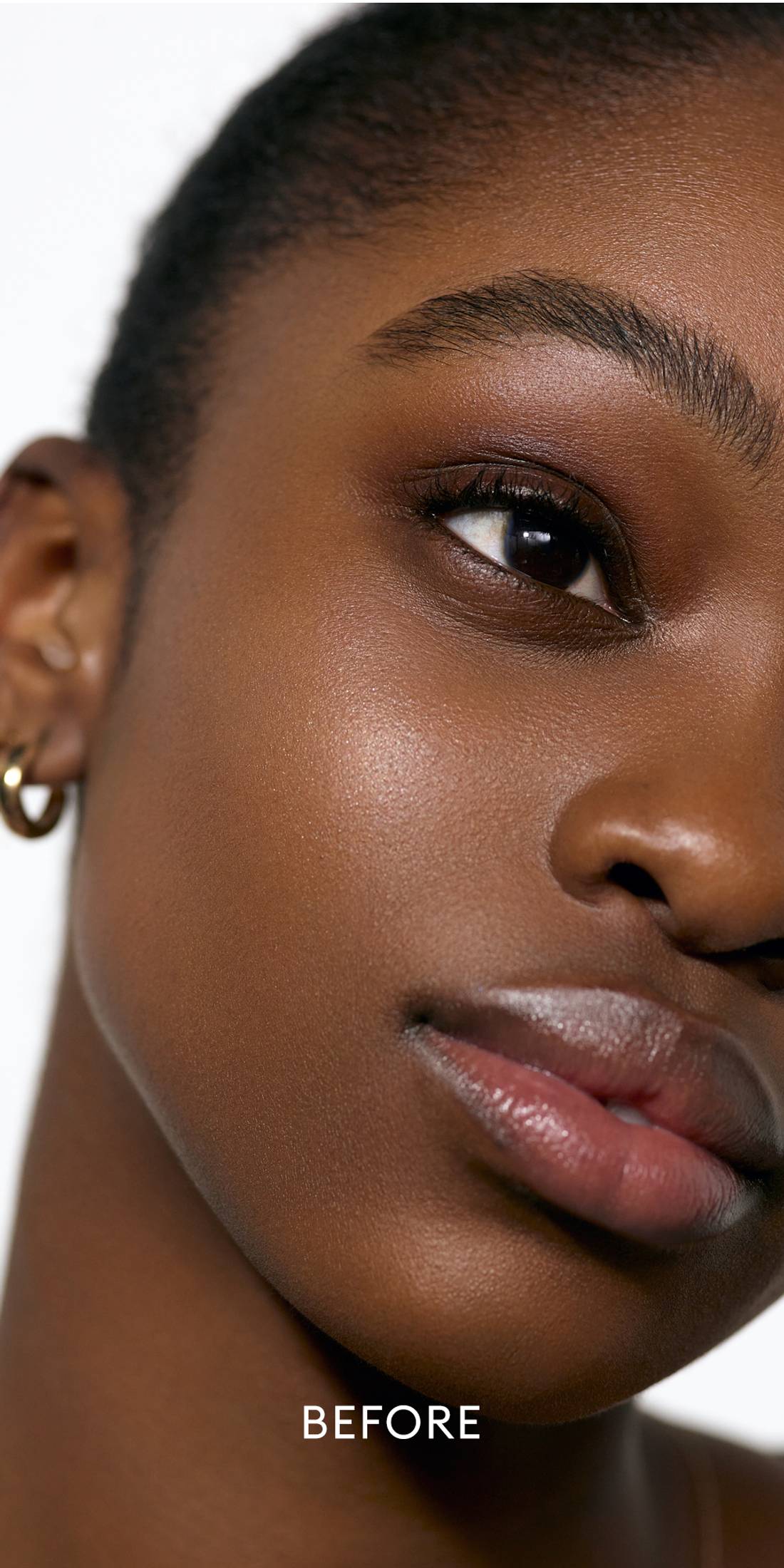 Before image of deep skin tone model wearing the Solar Radiance Hydrating Cream Highlight in shade Lustrous 1